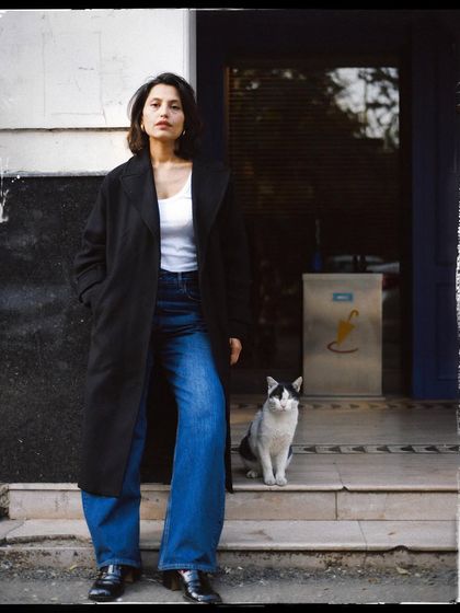 A powerful stance. The woman and cat stand as equals in this beautifully composed black and white photograph.