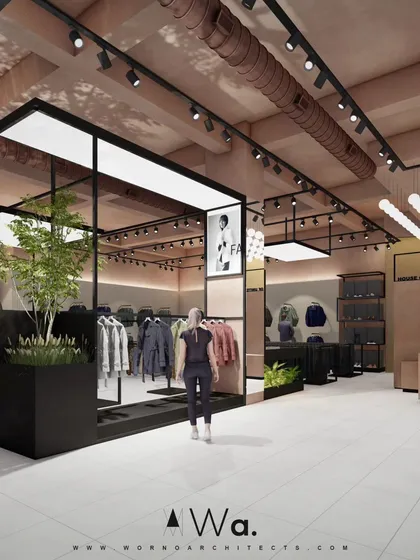 Another view of the apparel store, highlighting the use of black metal frames to create distinct display zones. We incorporated planters with greenery to bring a touch of nature indoors and soften the industrial design.