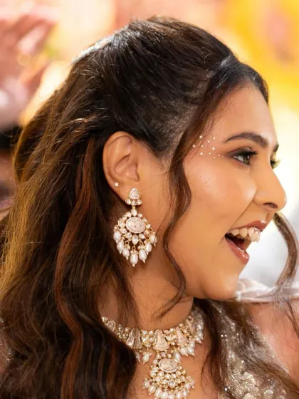 A close-up of the delicate rhinestone details near her eye, adding a touch of modern sparkle to her reception look. It's all about the little things.