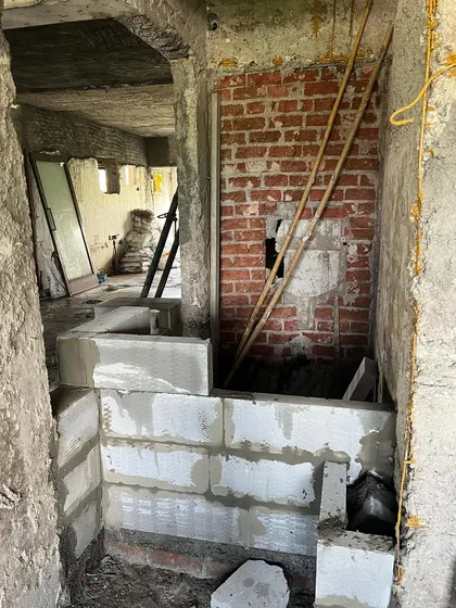 The "before" shot of the pink powder room. This image reveals the raw, unfinished space before we transformed it with bold color, custom concrete work, and elegant terrazzo, demonstrating the power of a strong design vision.