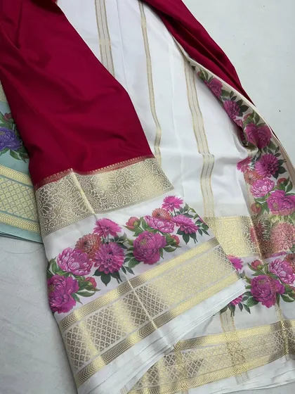 A classic combination of white and maroon in a semi-Mysore crepe saree with a pink floral Kalamkari border.