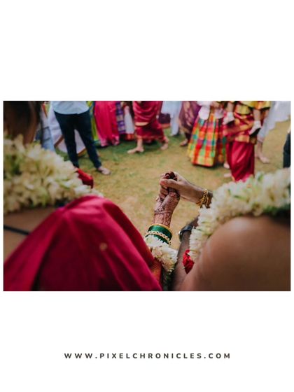 An over-the-shoulder shot of the couple holding hands, focusing on the connection between them.
