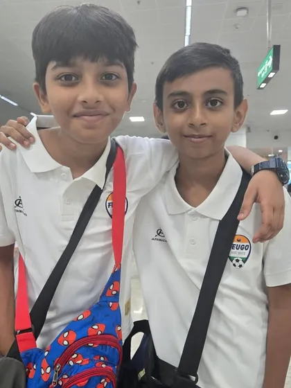 Two of our academy players at the airport, excited for the competition.