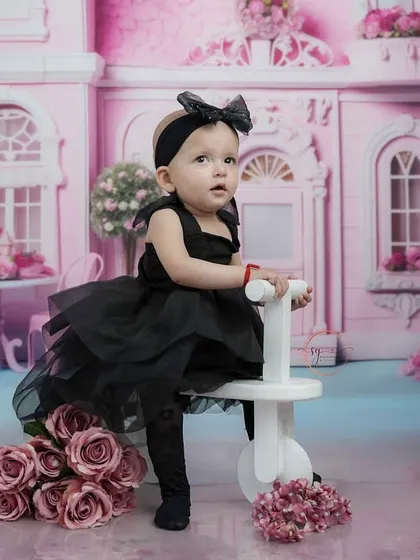 For the little fashionista, I offer creative themed shoots like this chic pink dollhouse setup. It's a fun way to play dress-up and create truly unique portraits for your child.