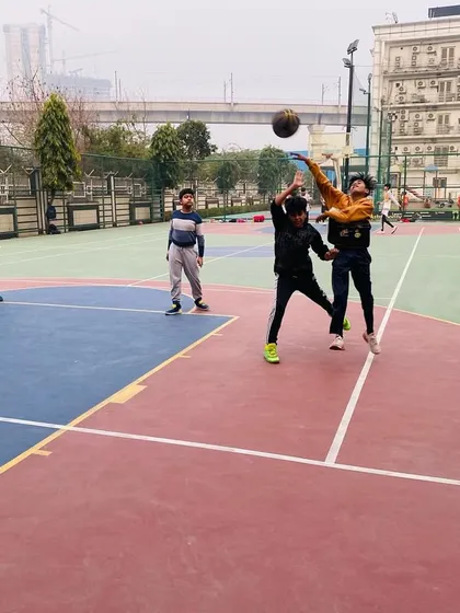 A contested shot at the rim, highlighting the competitive nature of our drills.