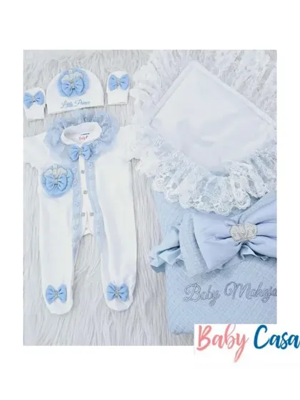 This "Little Prince" set in blue and white is perfect for a naming ceremony. The romper and wrap are detailed with lace, bows, and a heart shaped appliqué for a touch of sweetness.