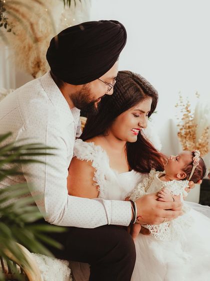 A beautiful family portrait capturing a candid moment of interaction with their newborn daughter.