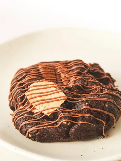 Dive into decadence with our triple chocolate chunk cookie, drizzled with more chocolate and topped with a chocolate-dipped wafer.