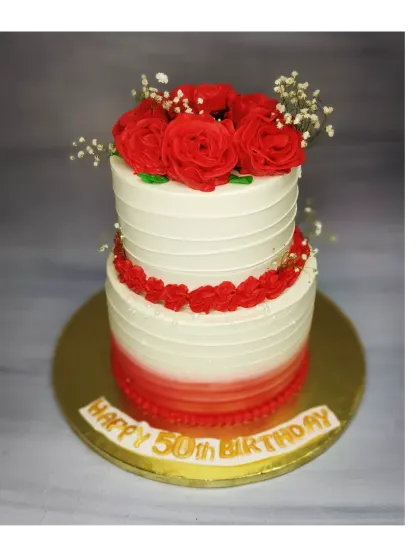 Celebrating a 50th birthday with this classic red and white two-tier cake. It's a fresh pineapple cake decorated with beautiful red roses, perfect for such a momentous occasion.