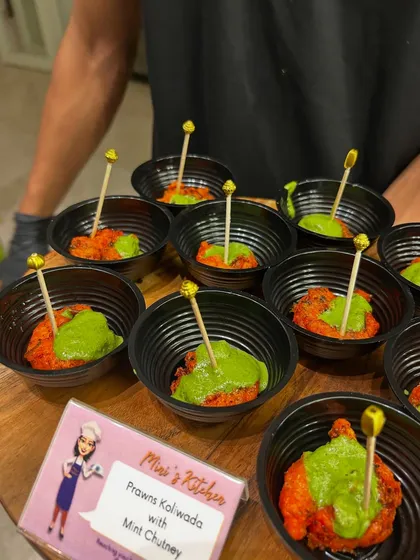 Prawns Koliwada with Mint Chutney, a classic Mumbai appetizer, served in individual bowls for easy enjoyment.
