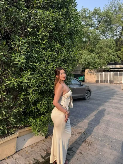 A side profile of the cream co-ord, showing the flattering silhouette of the maxi skirt.
