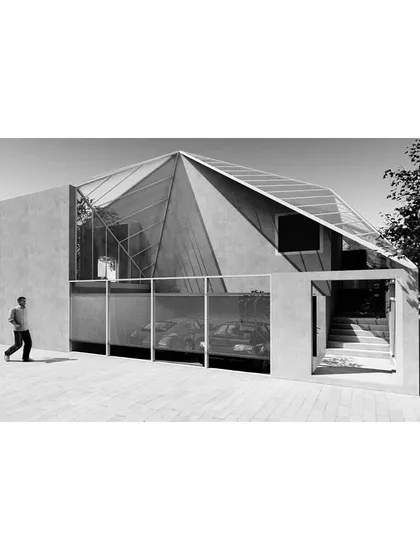 The design for this suburban home leveraged the site's natural gradient to create its unique sectional arrangement, with living spaces organized around the central sunken court.