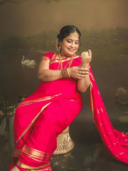 A close-up portrait showing the beautiful details of the jewelry and the rich color of the saree. These painting-style sessions are perfect for capturing grace and tradition.