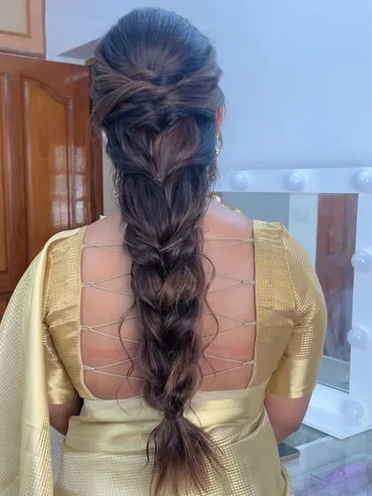 A messy, textured braid that is perfect for a modern bride or bridesmaid. The style is effortlessly chic and full of volume.