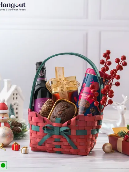 Spread festive cheer with the Joyful Jubilee Christmas Hamper. This classic red and green basket is filled with a plum cake, ginger cookies, a cookie tin, and a bottle of alcohol-free wine.