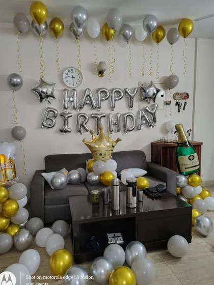 Another angle of the silver and gold themed birthday room decoration.