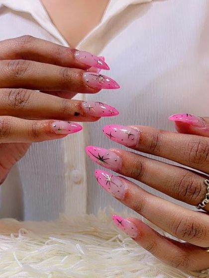 A dreamy combination of pink ombre and delicate starburst designs. These stiletto extensions are perfect for anyone who loves a touch of sparkle and magic on their nails.