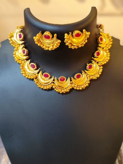 This Chandrahaar with red stones is perfect for adding a pop of color to your traditional attire.