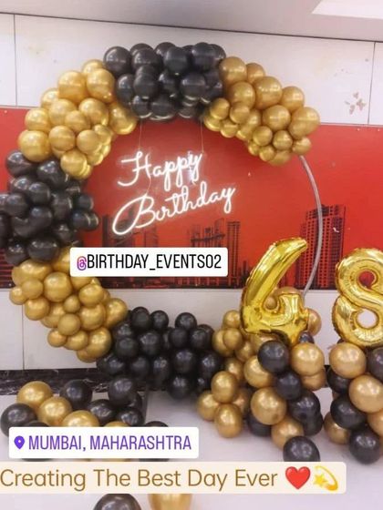 A bold black and gold balloon ring for a 48th birthday, creating a striking and elegant statement piece for the party.