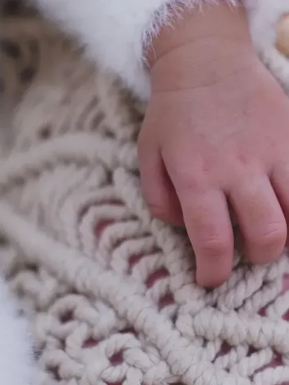 A macro shot of a newborn's tiny hand resting on a textured blanket. I love focusing on these small details that highlight how little they once were.