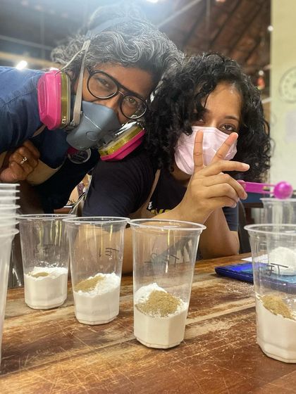 A fun, masked up moment during a glaze mixing session, showing the science and safety that goes into preparing our materials.