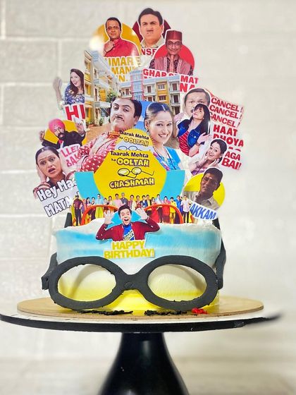 A close-up on the edible glasses and detailed toppers of our Tarak Mehta cake.