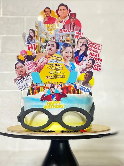 A close-up on the edible glasses and detailed toppers of our Tarak Mehta cake.