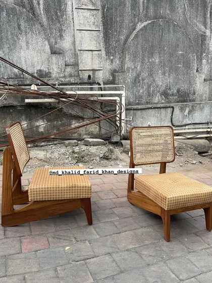 The 'Kangaroo' chairs without cushions, showcasing the continuous flow of the wooden frame and the intricate cane work. This design is low, comfortable, and exceptionally stylish.