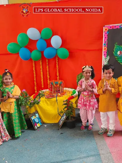 Our little Radhas and Krishnas pose by the Janmashtami decorations, radiating the divine and festive spirit of the occasion.