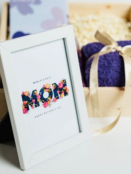 A close-up of the 'World's Best Mom' frame from the lavender-themed hamper.