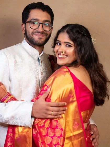 A sweet and relaxed portrait. The couple's comfortable embrace and a look towards the camera make for a lovely, engaging photo.
