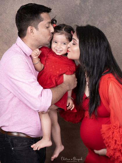 Kisses for the big sister! This is a beautiful, candid moment showing the love and affection in this growing family.