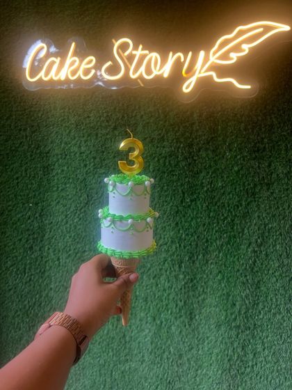 The trending cone cake! A mini two-tier cake served on an ice cream cone, perfect for a unique and individual treat.