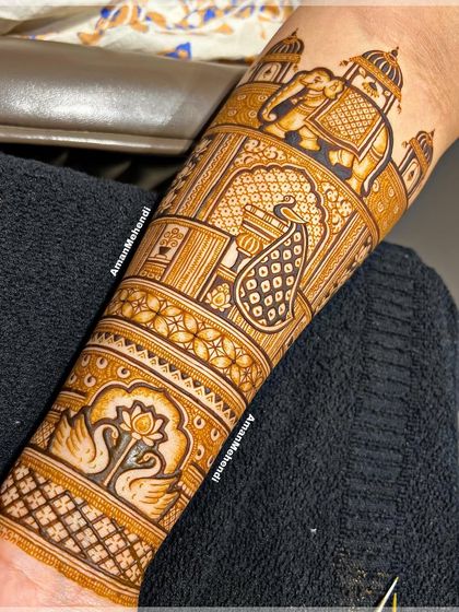 One of my favorite designs of the season, this arm piece features a majestic elephant, a detailed peacock, and beautiful swan motifs, all set against a backdrop of palace architecture.