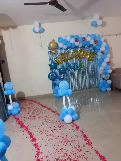 A full view of a 'Welcome Boy' home decoration, showing the petal-strewn path leading to the main balloon backdrop.