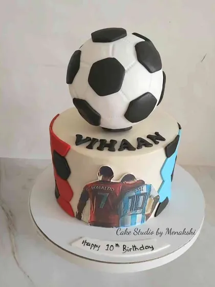 The ultimate cake for a young football fan celebrating his 10th birthday. I designed this piece to feature his two heroes, Ronaldo and Messi, complete with an edible football on top.