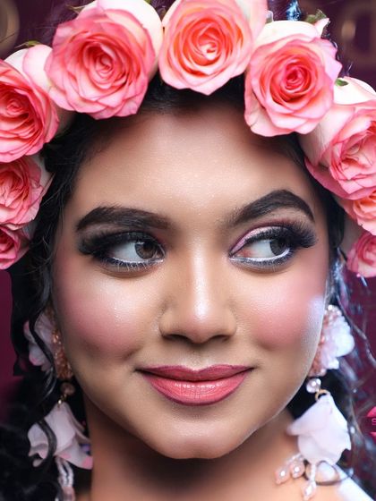 This shot captures the playful and happy side of the bride. The makeup is designed to look beautiful both in person and in photographs, with a focus on enhancing her natural features.