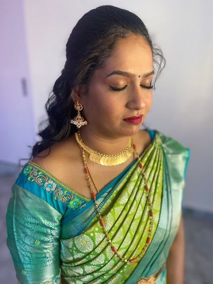 A close-up of the makeup, showing the soft, neutral eyeshadow that lets the bold red lip be the star of the show.