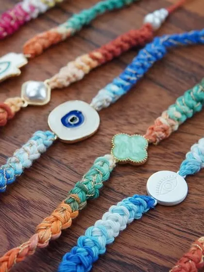 A close-up of the different charm rakhis I offer, each one unique.