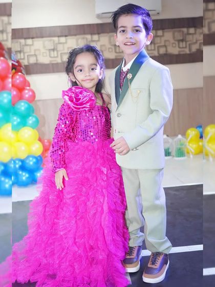 A brother and sister duo pose together in their stylish party outfits. I love capturing sibling bonds.