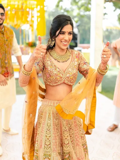 Thumbs up for a fun Haldi celebration! This bride's makeup is fresh, flawless, and designed to last through all the festivities.