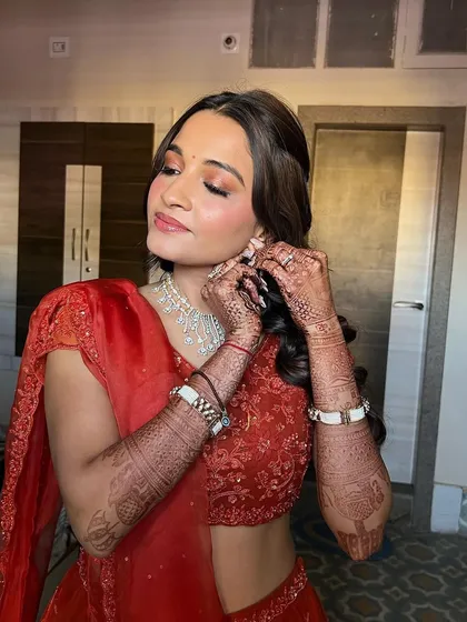 A candid moment, showing the beautiful coral makeup. This look is perfect for a daytime event, adding a touch of warmth and radiance.