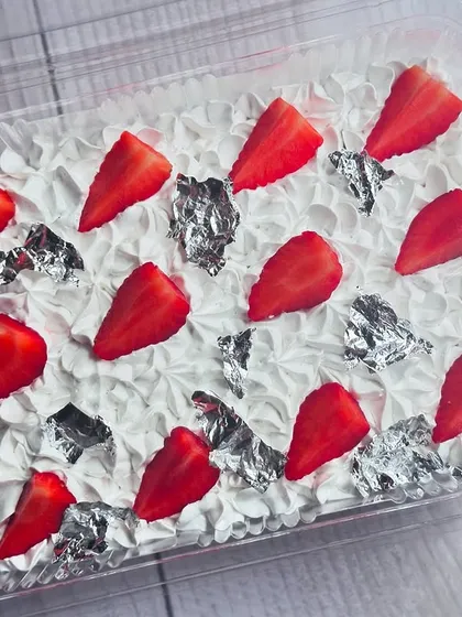 My Strawberry Tres Leches tub is a seasonal delight. I soak a moist sponge in a trio of milks and top it with fresh, juicy strawberries and delicate silver leaf.