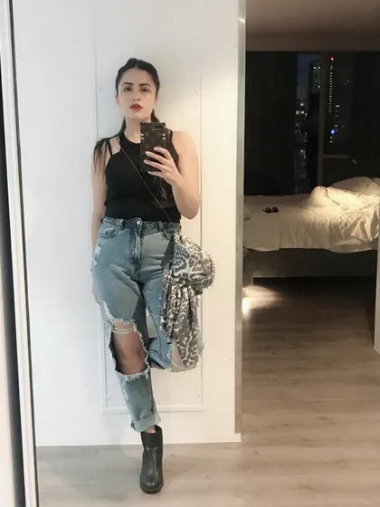 A denim makeover is one of my favorite services. Here, I've styled a pair of heavily distressed baggy jeans with a simple black tank top and black boots for an edgy, concert-ready look that’s full of personality.