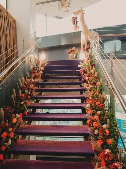 We decorated the entire staircase entrance with florals and pampas grass, leading guests up to the celebration.