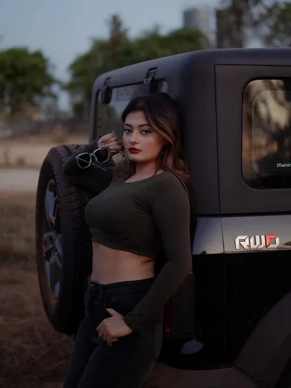 A duplicate of image 369, this portrait of a model with a Thar jeep at dusk has a beautiful, atmospheric quality.