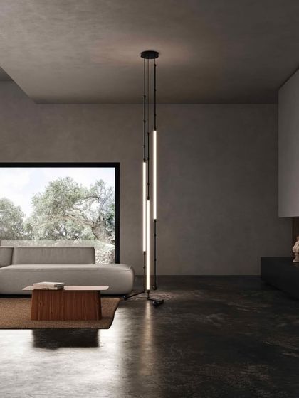 The Leda system is configured as a unique floor lamp, with its flexible tubes creating a vertical sculpture of light.