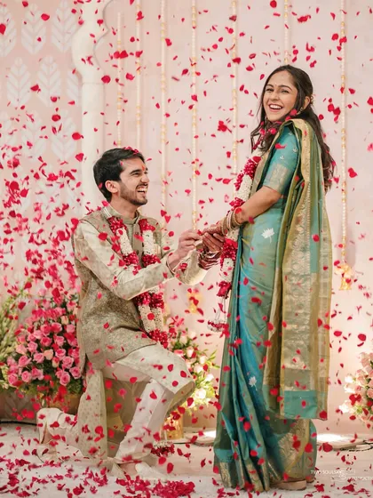 The pure, unscripted joy of a proposal. We are there to capture the peak emotions of your engagement ceremony, like this beautiful moment showered in rose petals.