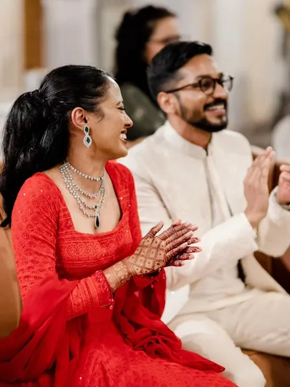 A modern Sangeet look featuring a sleek high ponytail and a bold red lip. This style is chic, comfortable, and perfect for a bride who wants to dance the night away.