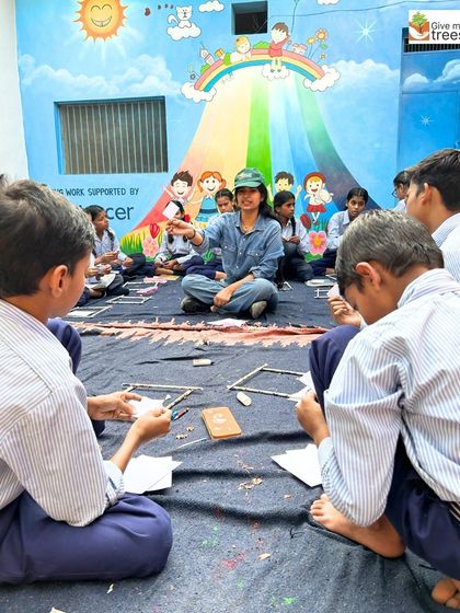 An instructor leads the workshop, guiding students through the process of making their nature-inspired art. The colorful mural in the background adds to the creative atmosphere.